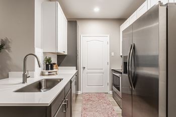A kitchen with stainless steel appliances and a sink